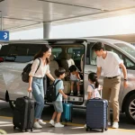 A family loading luggage into a minivan for their airport transfer, showcasing the convenience of spacious vehicle options.