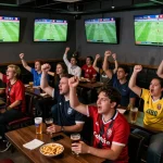 Cakhia TV live football match at a vibrant sports bar with fans celebrating, creating a dynamic watch experience.