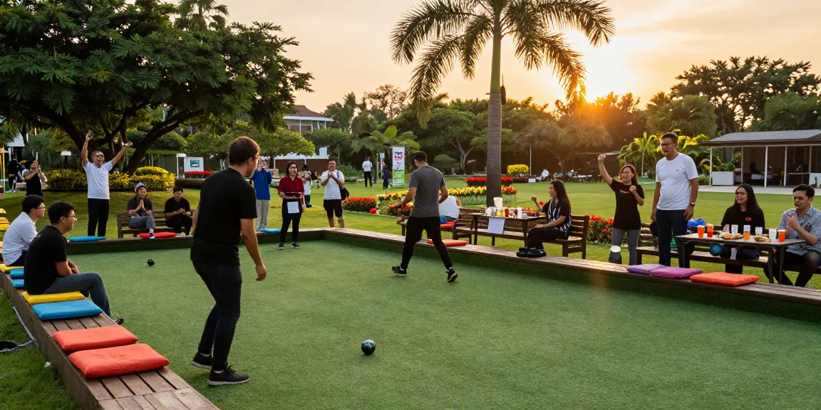 Players enjoying petanque at FOPI Kota Makassar court during sunset, showcasing community spirit and vibrant atmosphere.